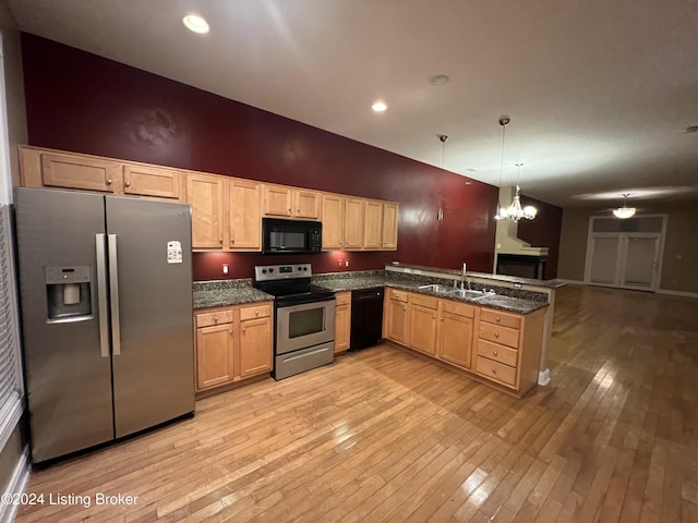 kitchen with sink, black appliances, light hardwood / wood-style flooring, a notable chandelier, and hanging light fixtures