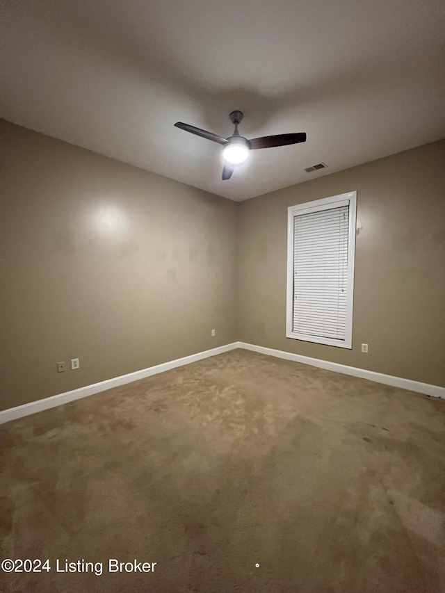 unfurnished room featuring ceiling fan and carpet floors