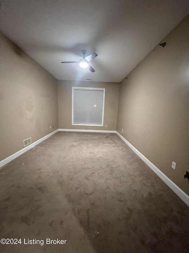 spare room featuring ceiling fan and carpet floors