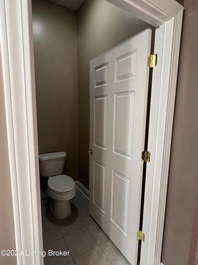 bathroom featuring tile patterned flooring and toilet