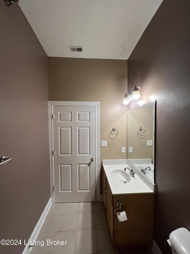 bathroom featuring tile patterned flooring, vanity, and toilet