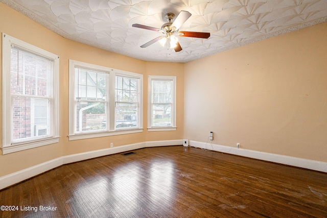 unfurnished room with plenty of natural light, ceiling fan, and wood-type flooring