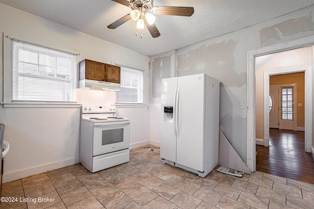 kitchen with ceiling fan, a healthy amount of sunlight, white appliances, and light wood-type flooring