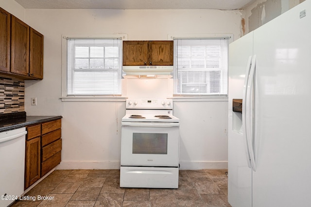 kitchen with white appliances and backsplash