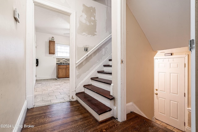 stairs featuring hardwood / wood-style flooring