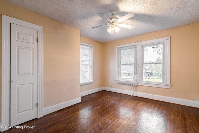 spare room featuring ceiling fan, dark hardwood / wood-style flooring, and a textured ceiling