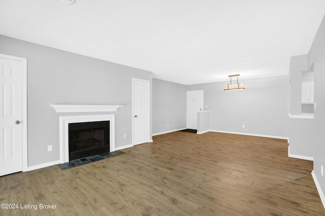 unfurnished living room with dark wood-type flooring