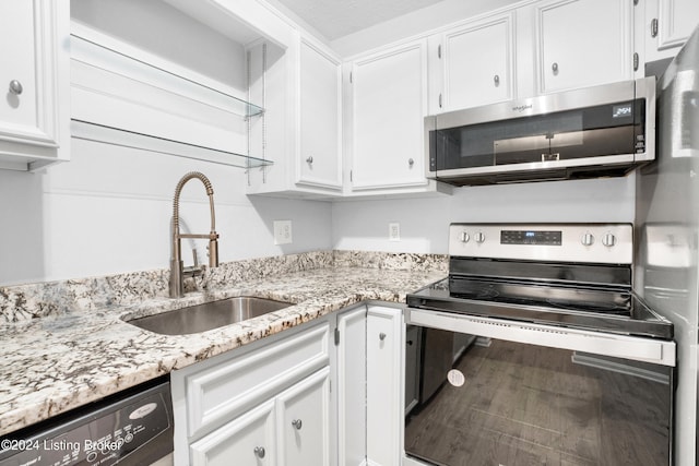 kitchen featuring white cabinets, sink, wood-type flooring, and stainless steel appliances