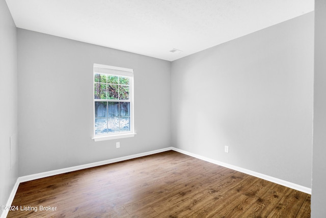 unfurnished room featuring dark wood-type flooring