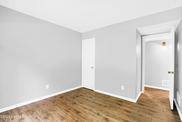 spare room with hardwood / wood-style flooring