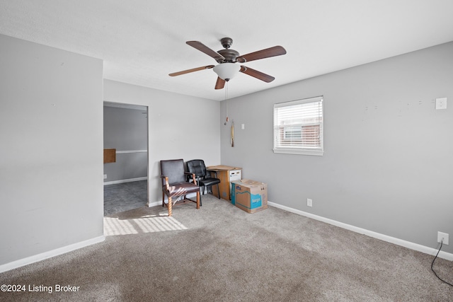 interior space with carpet flooring and ceiling fan