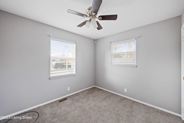 unfurnished room with carpet flooring, ceiling fan, and plenty of natural light