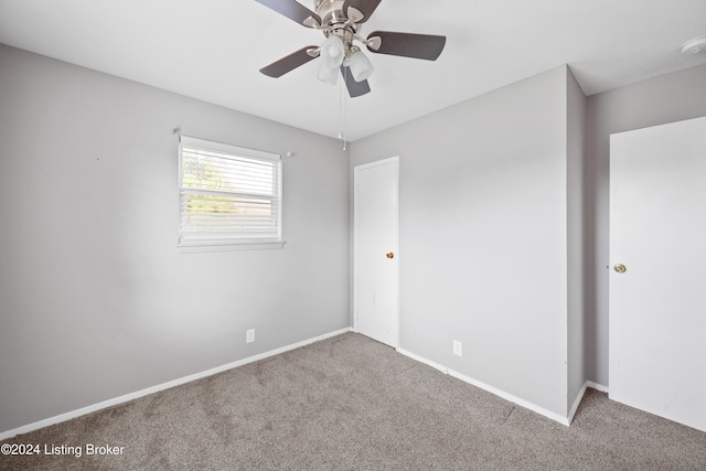 unfurnished room featuring light carpet and ceiling fan