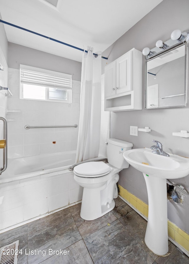 full bathroom with toilet, sink, and shower / tub combo with curtain