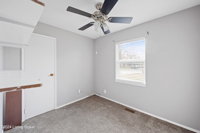 spare room featuring carpet floors and ceiling fan