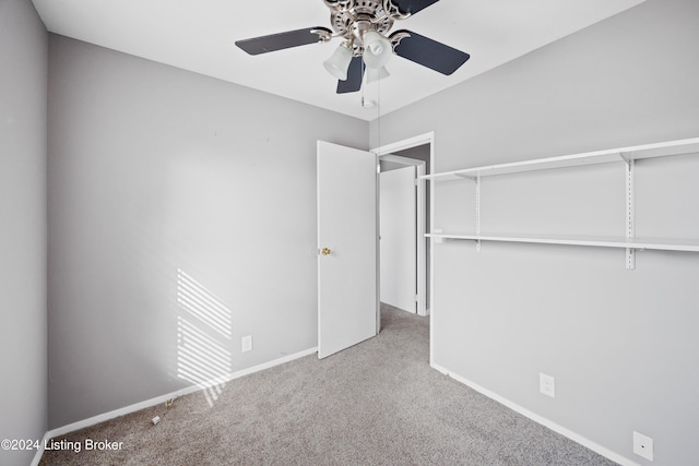 unfurnished bedroom with light carpet, a closet, and ceiling fan