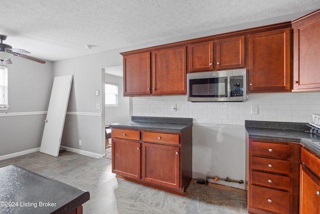 kitchen with ceiling fan, a textured ceiling, and tasteful backsplash