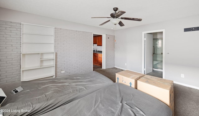 carpeted bedroom featuring ceiling fan, ensuite bathroom, and sink