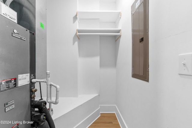 bathroom featuring electric panel and hardwood / wood-style flooring