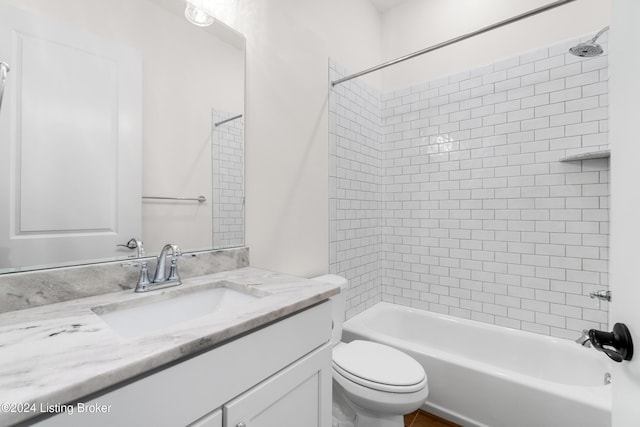 full bathroom featuring vanity, toilet, and tiled shower / bath