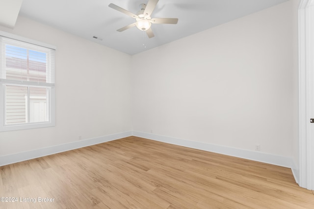 empty room with light hardwood / wood-style flooring and ceiling fan