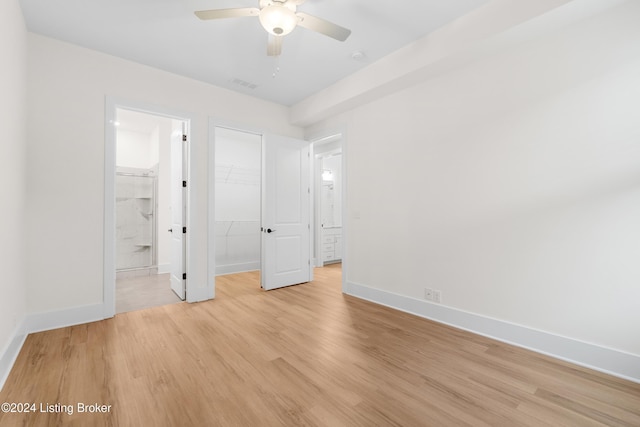 unfurnished bedroom with ensuite bath, ceiling fan, and light hardwood / wood-style flooring