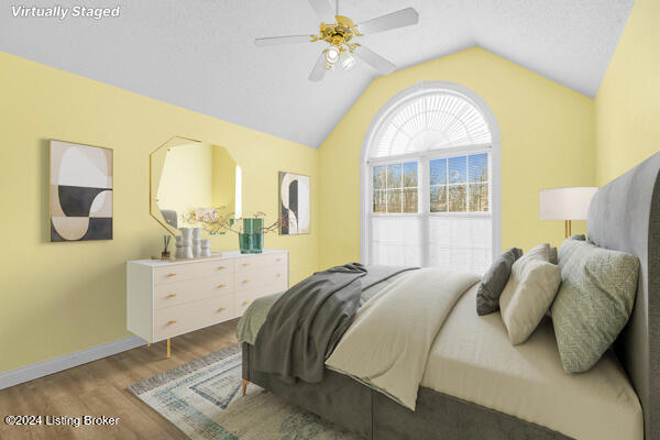 bedroom featuring hardwood / wood-style flooring, ceiling fan, and lofted ceiling