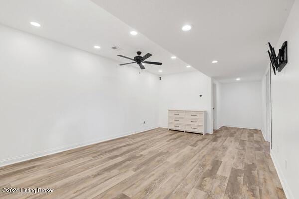 basement featuring ceiling fan and light wood-type flooring