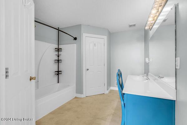 bathroom with vanity and shower / washtub combination