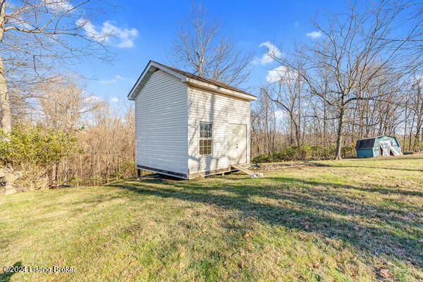 view of outbuilding with a lawn