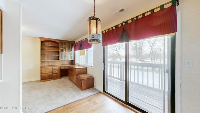 interior space featuring light wood-type flooring and built in desk