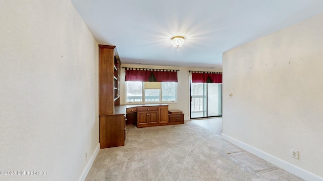 unfurnished living room featuring light carpet