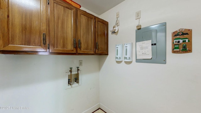 washroom with cabinets, electric panel, and hookup for a washing machine