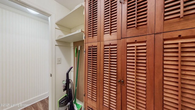 details with ornamental molding and hardwood / wood-style flooring