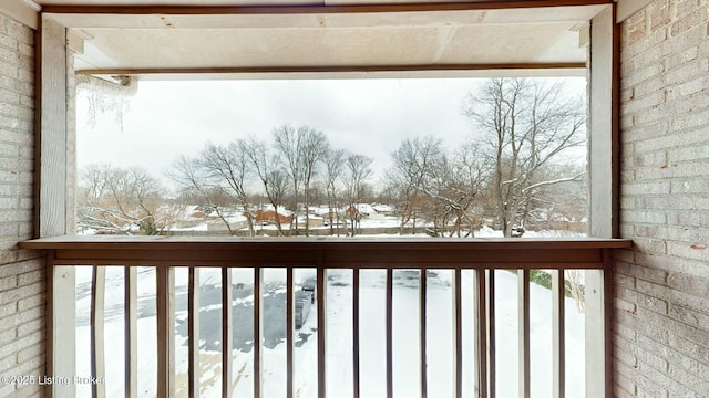 view of snow covered back of property