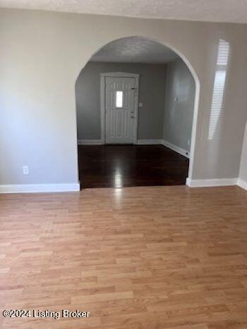 entryway featuring a textured ceiling and hardwood / wood-style flooring