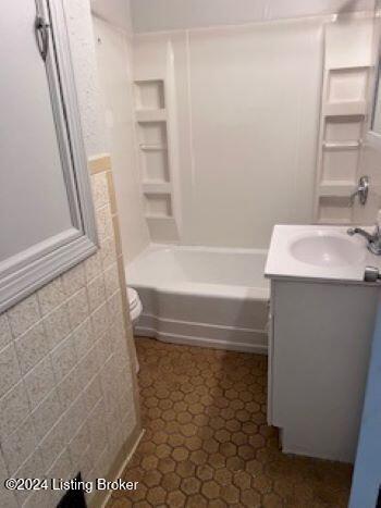 full bathroom with tile patterned flooring, vanity, toilet, and shower / tub combination