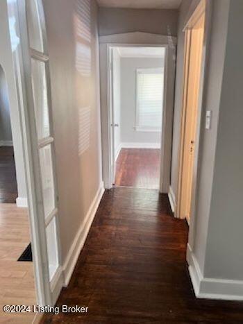 hallway with dark wood-type flooring