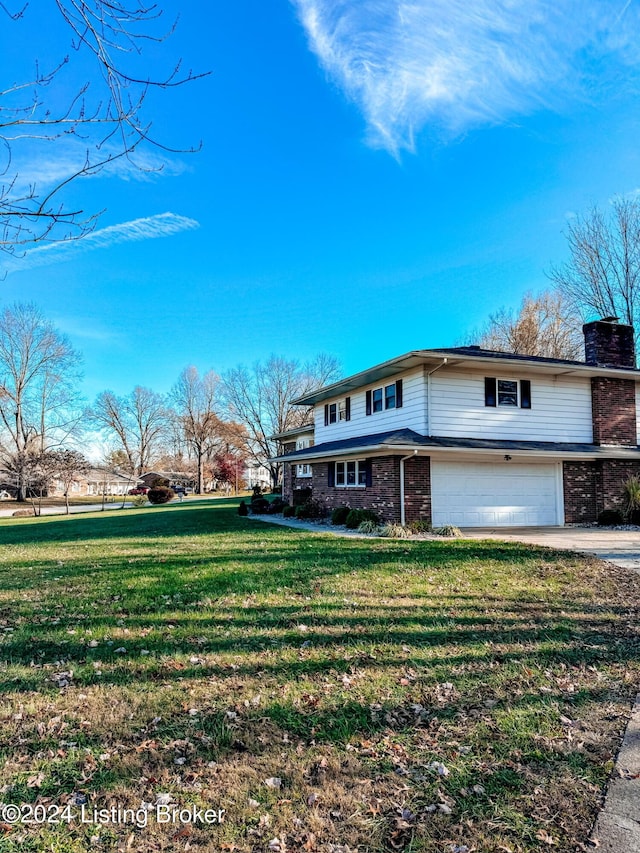 view of property with a garage and a front lawn