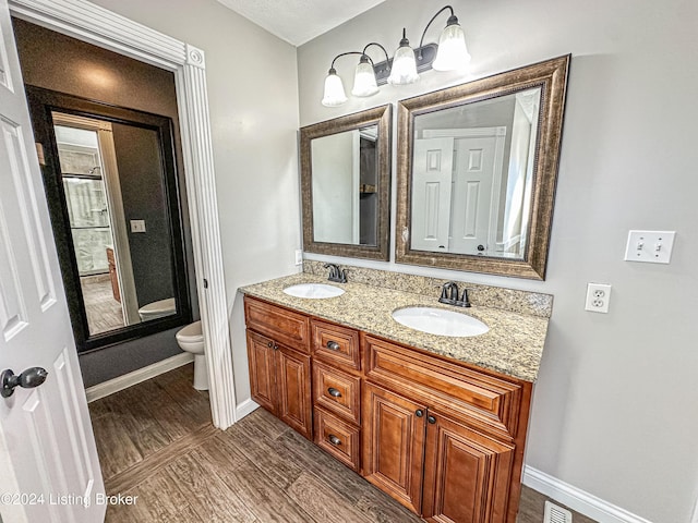 bathroom featuring hardwood / wood-style floors, vanity, and toilet