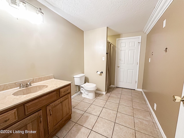 bathroom featuring tile patterned floors, vanity, toilet, and a textured ceiling