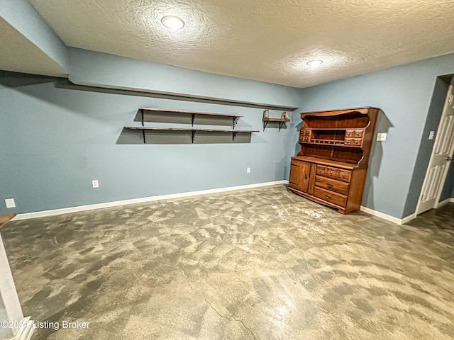 interior space featuring carpet and a textured ceiling