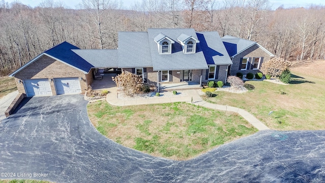 cape cod-style house with a front lawn, a porch, and a garage