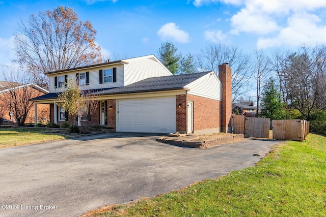 front facade featuring a front yard and a garage