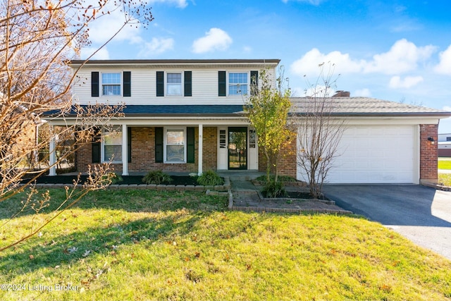 view of property featuring a front yard, a porch, and a garage