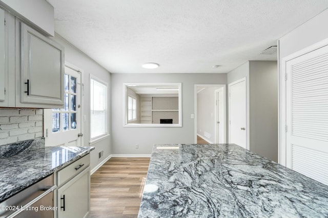 bedroom featuring a closet, a textured ceiling, and light hardwood / wood-style flooring