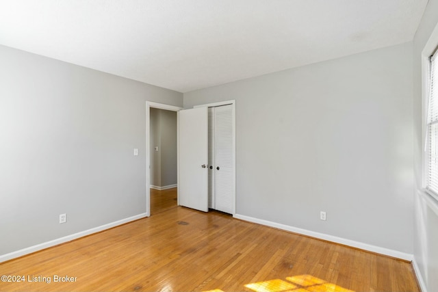 unfurnished room with hardwood / wood-style flooring