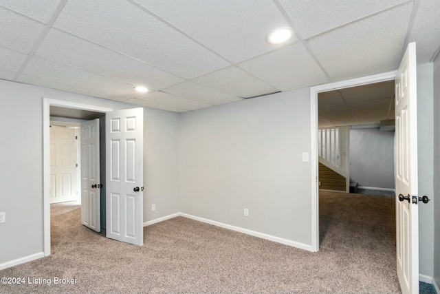 basement with a drop ceiling and carpet floors