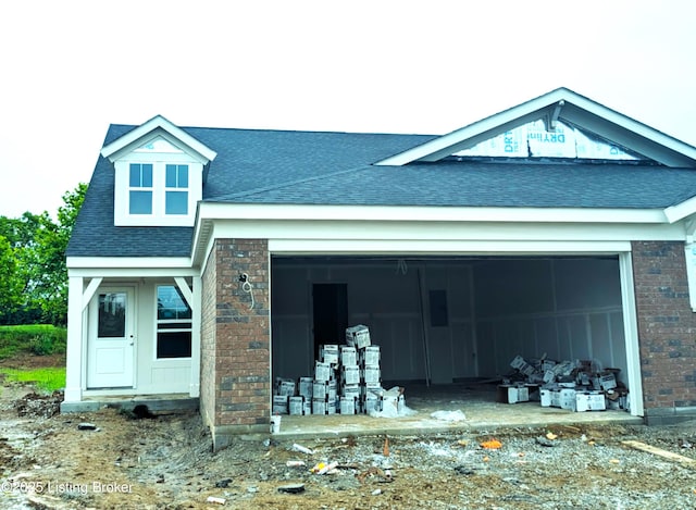 144 Exploration Path Unit 18B, Shelbyville, KY 40065 - view of front facade with a shingled roof, brick siding, and an attached garage