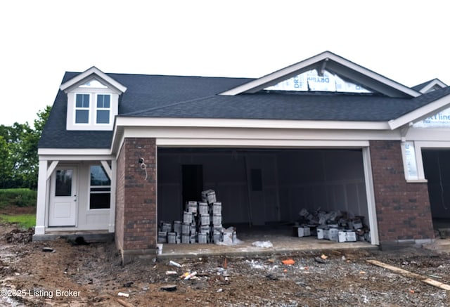 144 Exploration Path Unit 18B, Shelbyville, KY 40065 - back of house featuring brick siding, a garage, and a shingled roof